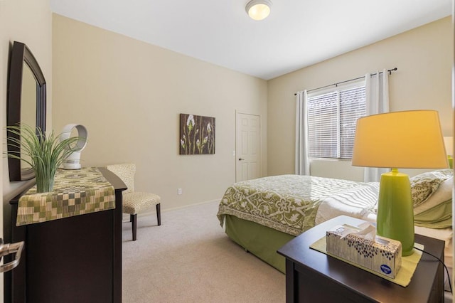 bedroom featuring light carpet