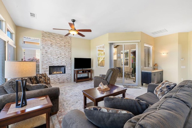 living room with a fireplace and ceiling fan