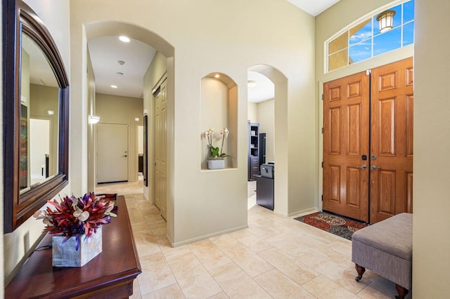 foyer entrance with a towering ceiling