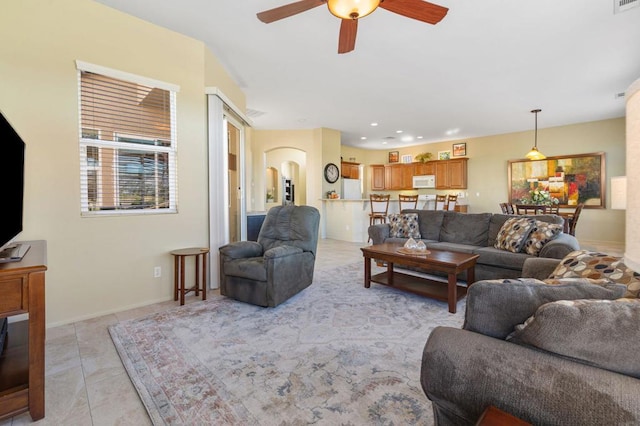 living room with ceiling fan and light tile patterned floors