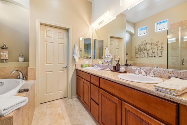 bathroom with vanity, tile patterned floors, and plus walk in shower