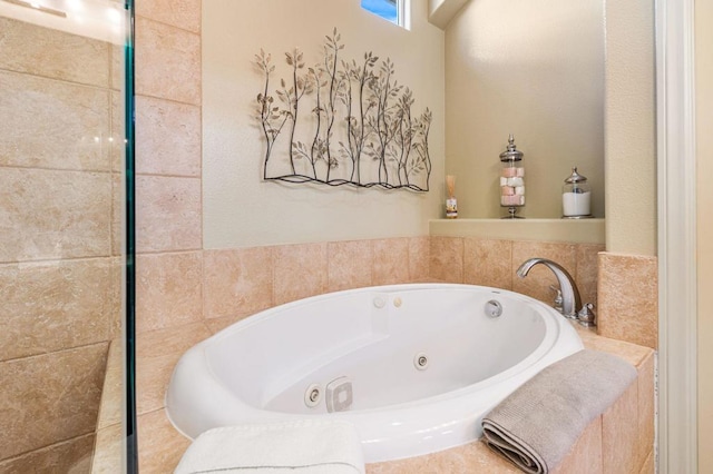 bathroom with a tub to relax in