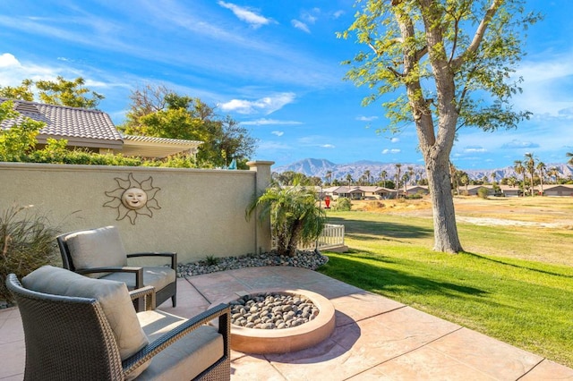 view of patio / terrace featuring a mountain view and a fire pit