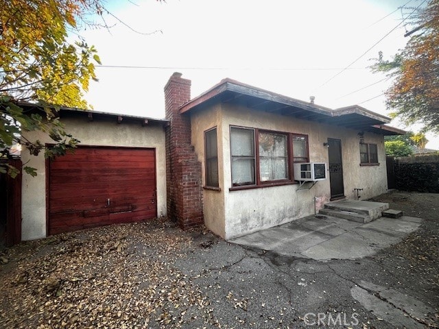 view of front facade with a garage and cooling unit