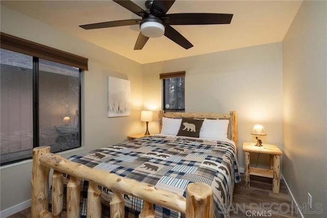 bedroom featuring ceiling fan and dark hardwood / wood-style floors