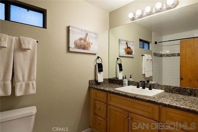 bathroom featuring toilet and vanity