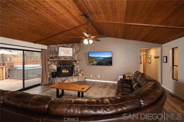 living room with wood ceiling, hardwood / wood-style floors, vaulted ceiling, and a stone fireplace