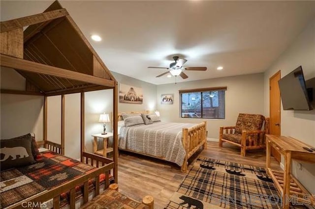 bedroom with ceiling fan and hardwood / wood-style flooring