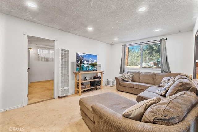 carpeted living room featuring a textured ceiling