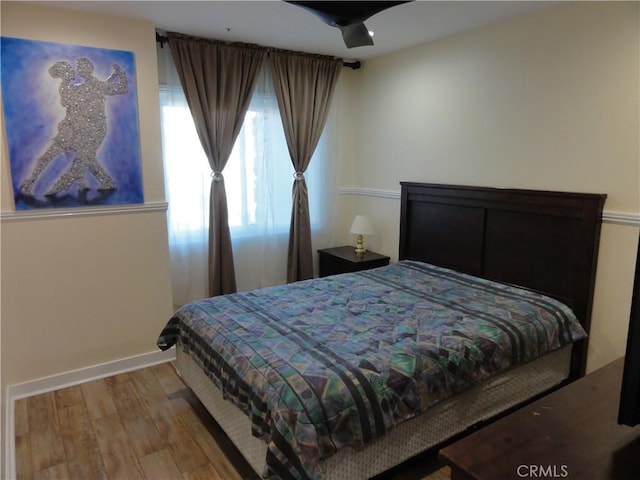 bedroom with hardwood / wood-style floors and ceiling fan