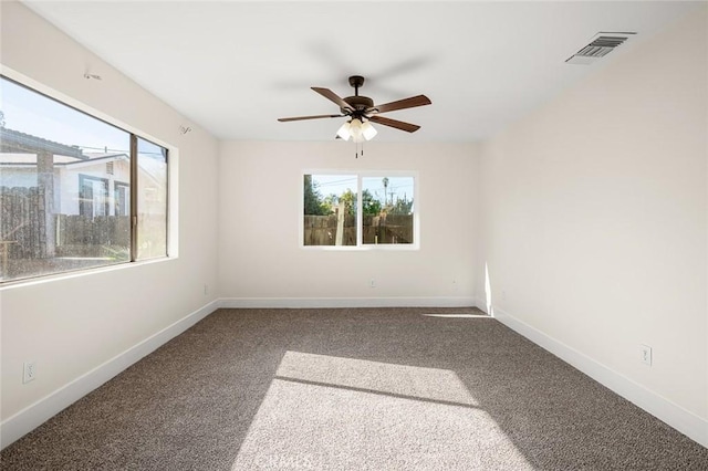 carpeted spare room featuring ceiling fan