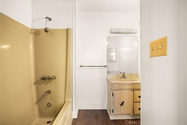 bathroom with shower / bathtub combination, wood-type flooring, and vanity