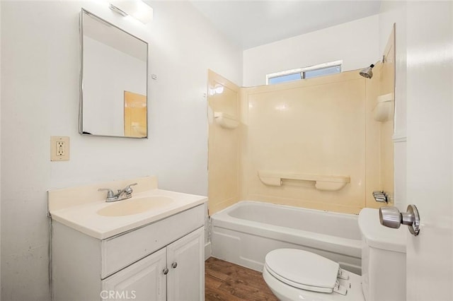 full bathroom with toilet, vanity, wood-type flooring, and tub / shower combination