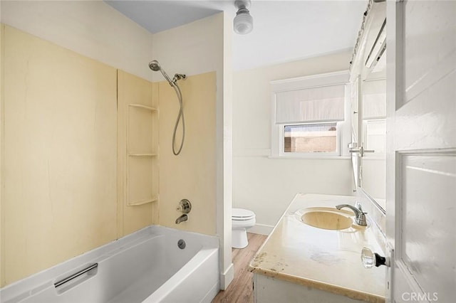 full bathroom with hardwood / wood-style floors, toilet, vanity, and  shower combination