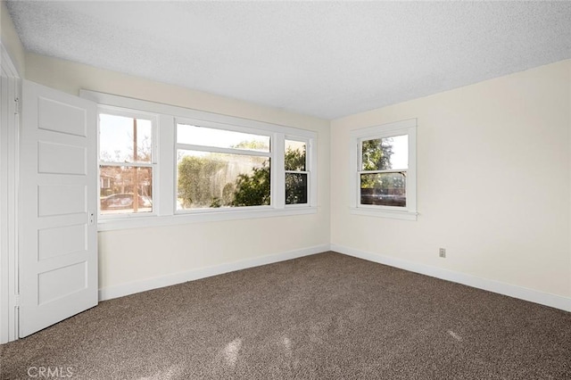 unfurnished room featuring a textured ceiling