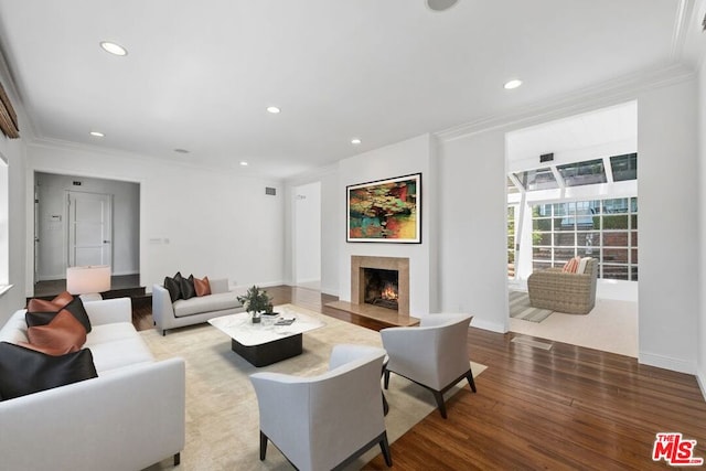 living room with hardwood / wood-style floors and crown molding