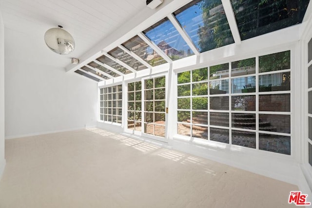 unfurnished sunroom with lofted ceiling with beams