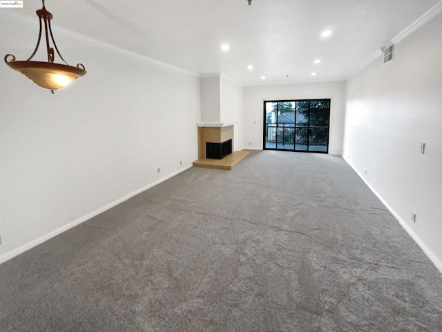 unfurnished living room with a multi sided fireplace, carpet, and crown molding