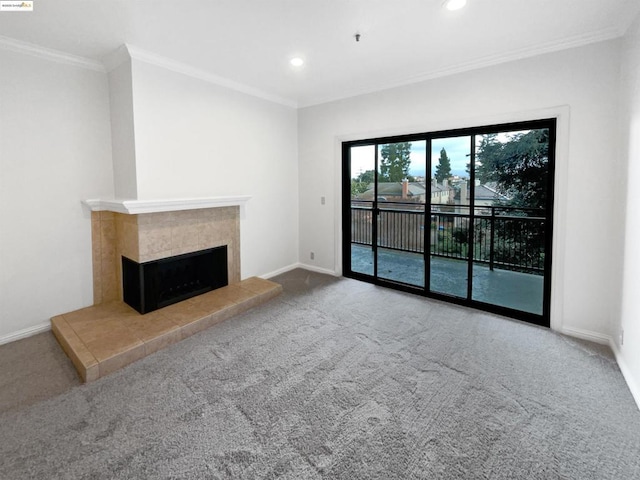 unfurnished living room with crown molding, a fireplace, and carpet flooring