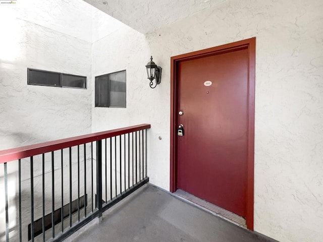 entrance to property featuring a balcony