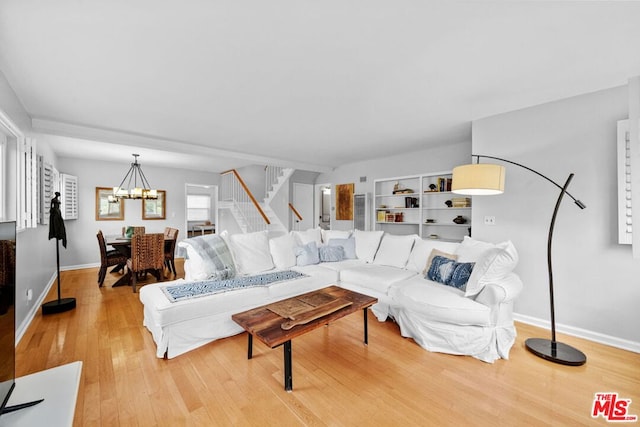 living room featuring hardwood / wood-style flooring and a notable chandelier