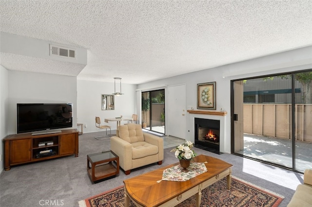 living room with a textured ceiling and light carpet