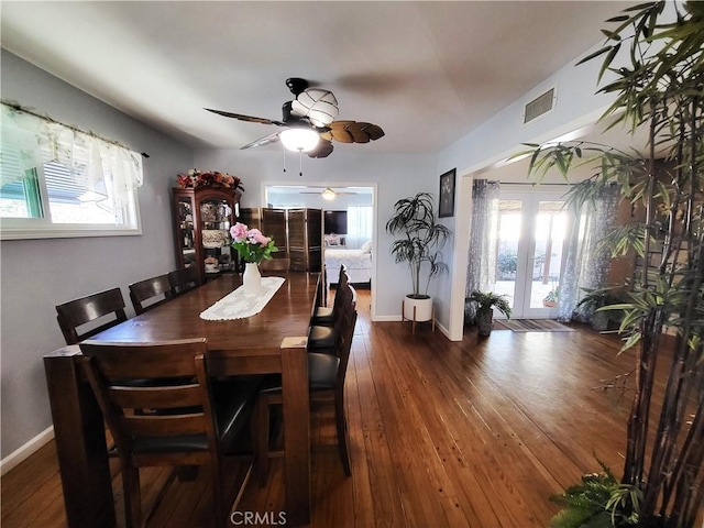 dining space featuring dark wood-type flooring, ceiling fan, and a wealth of natural light