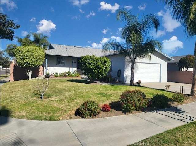 ranch-style home featuring a front lawn and a garage