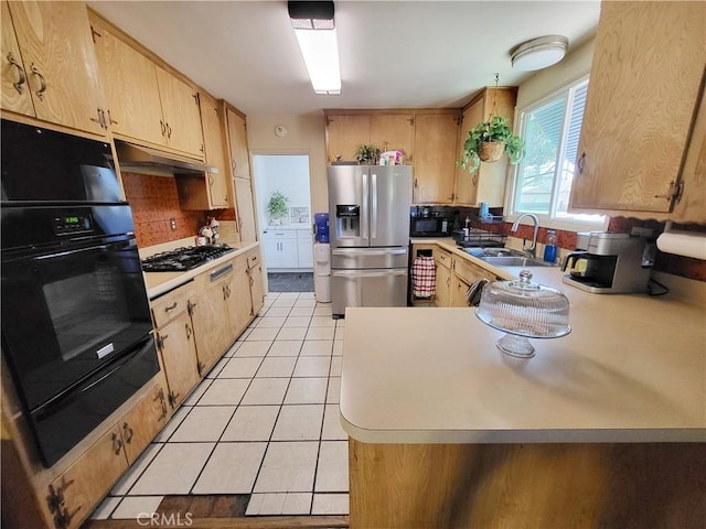 kitchen featuring black appliances, light brown cabinetry, sink, and light tile patterned floors