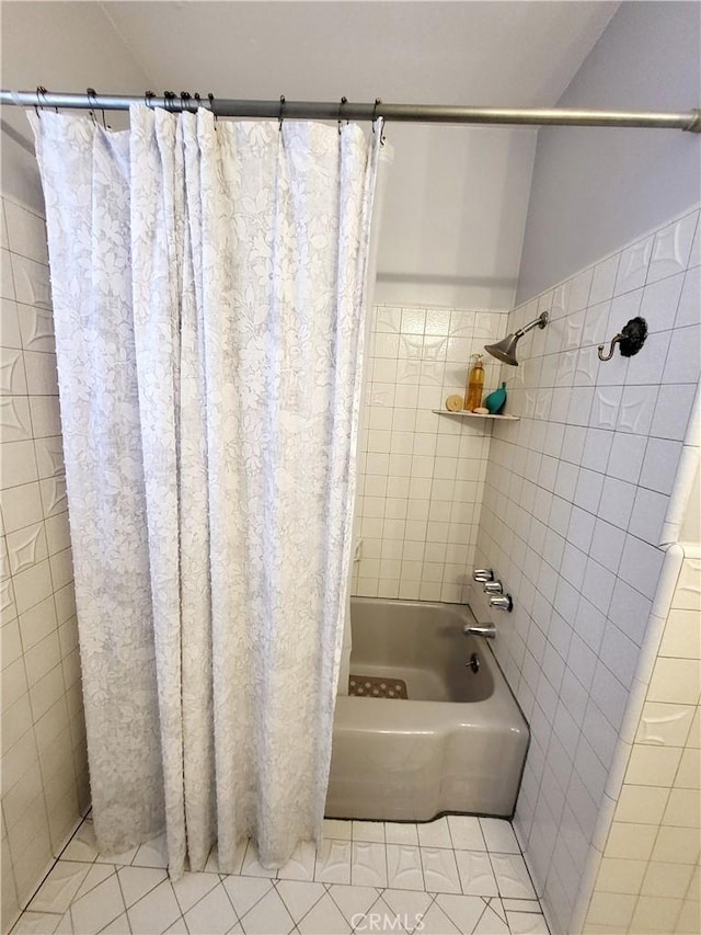 bathroom featuring tile patterned flooring and shower / bathtub combination with curtain