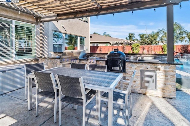 view of patio / terrace with area for grilling and exterior kitchen