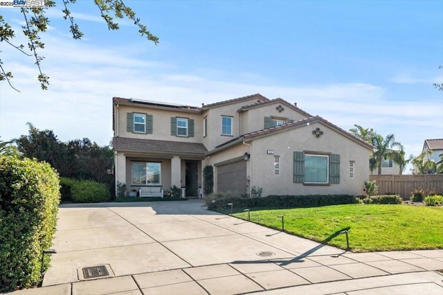 mediterranean / spanish-style house with a garage and a front yard