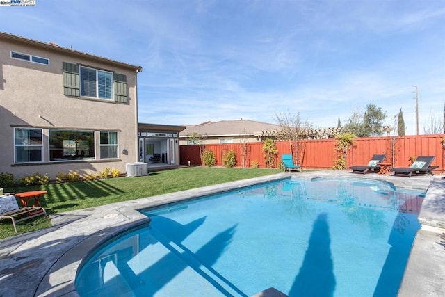 view of pool with central AC and a lawn