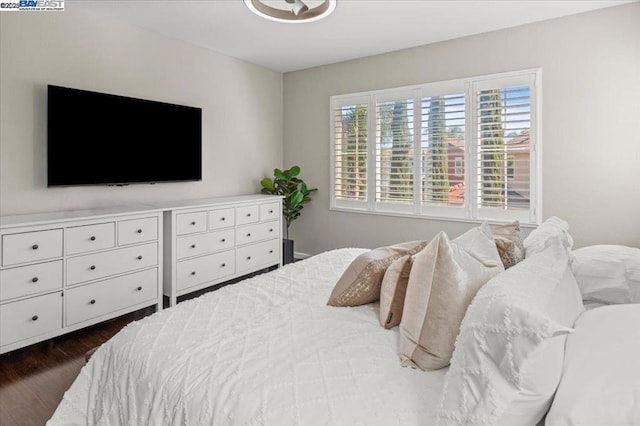 bedroom with dark hardwood / wood-style floors