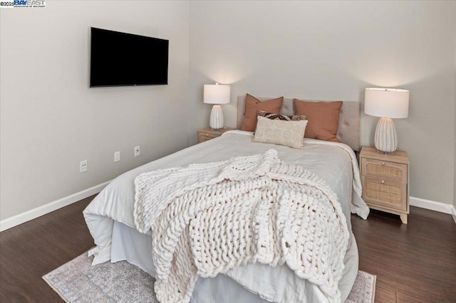 bedroom with dark hardwood / wood-style flooring