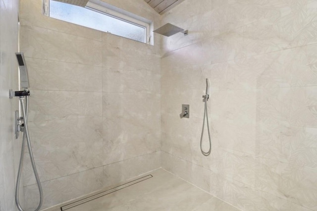 bathroom with tiled shower