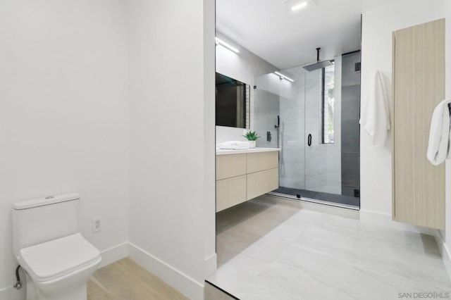 bathroom with walk in shower, vanity, and toilet