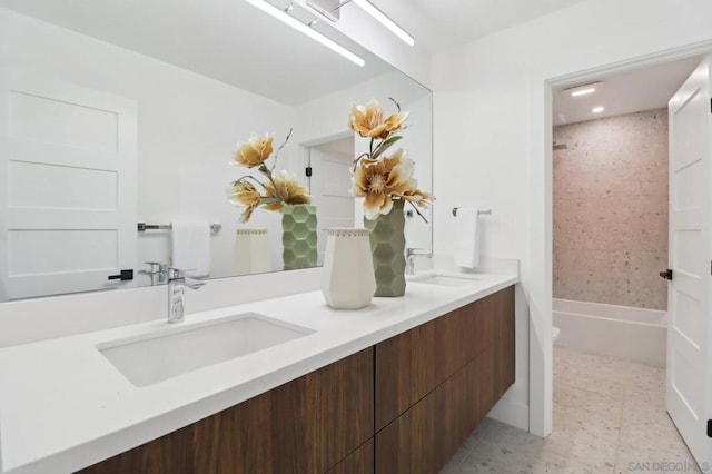 bathroom featuring vanity and tiled shower / bath combo