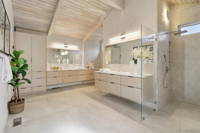 bathroom featuring a tile shower, vanity, wooden ceiling, and vaulted ceiling with beams