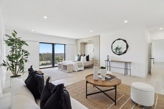 bedroom with light hardwood / wood-style floors and access to exterior