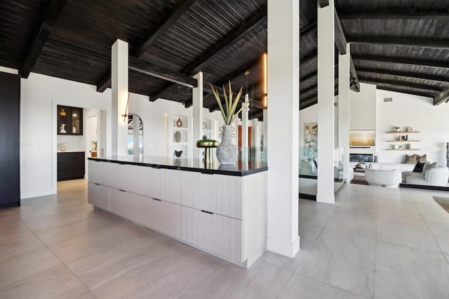 interior space featuring beam ceiling, wooden ceiling, and high vaulted ceiling