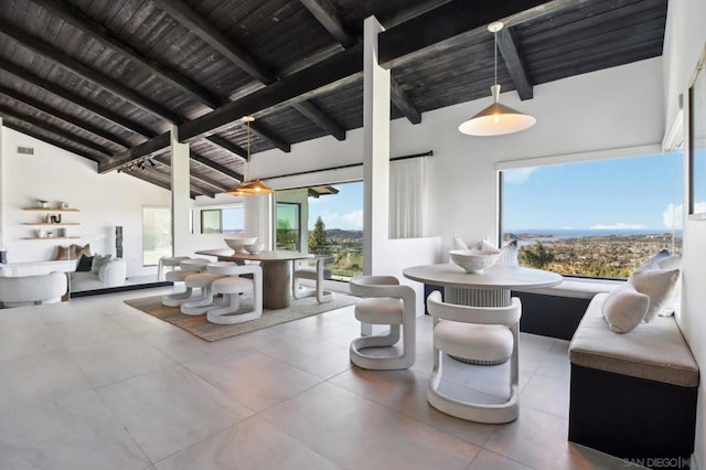 interior space featuring wooden ceiling, lofted ceiling with beams, and plenty of natural light