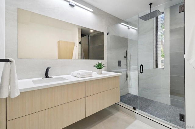 bathroom featuring walk in shower and vanity