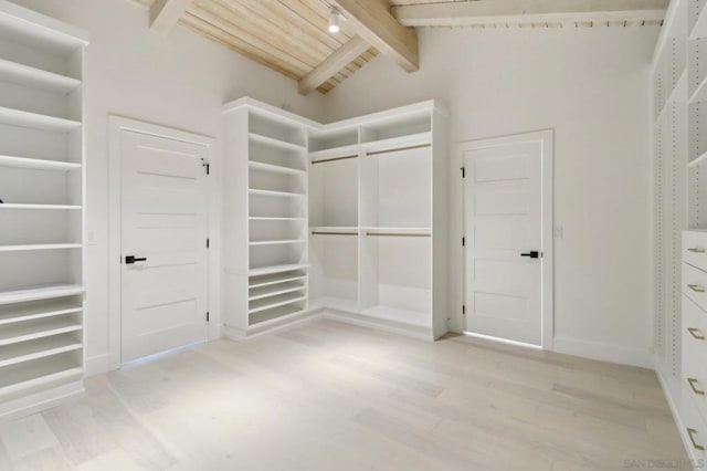 walk in closet featuring lofted ceiling with beams