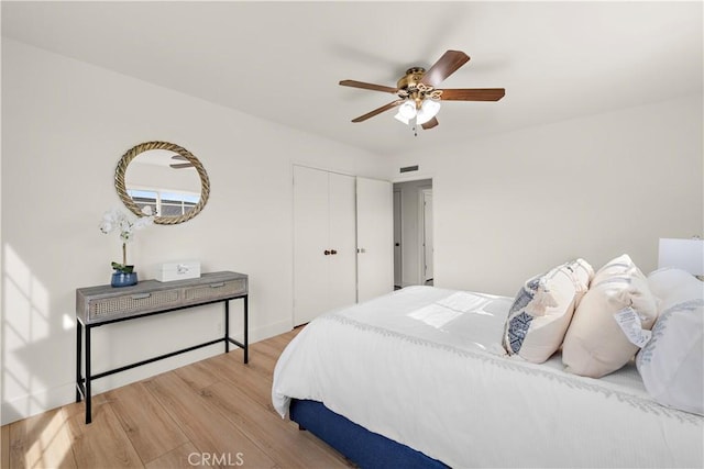 bedroom with a closet, ceiling fan, and hardwood / wood-style floors