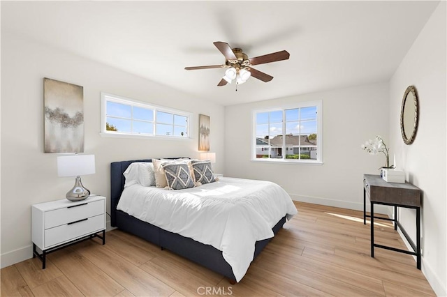 bedroom with light hardwood / wood-style floors and ceiling fan