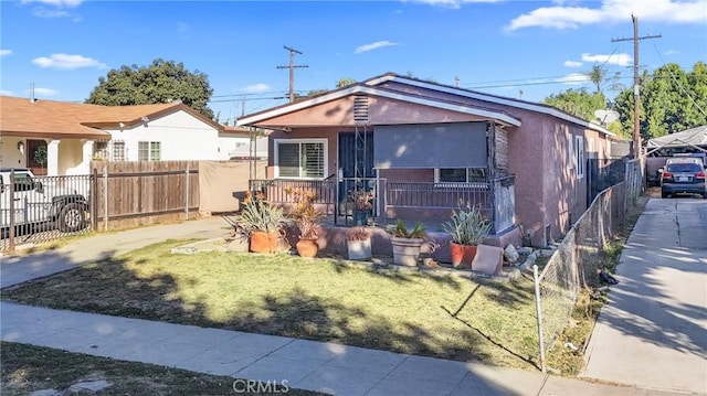 bungalow-style house with a front lawn