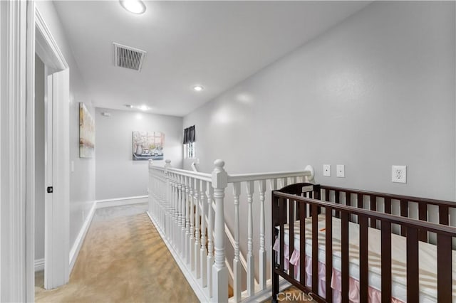 hallway featuring carpet, recessed lighting, visible vents, an upstairs landing, and baseboards