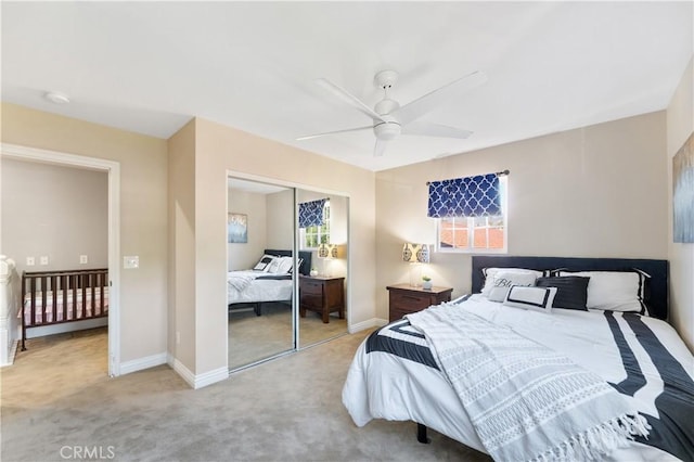 carpeted bedroom with a ceiling fan, a closet, and baseboards