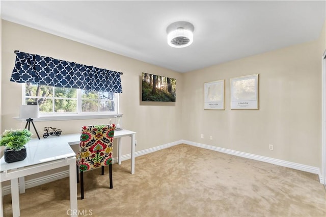 office space with baseboards and light colored carpet